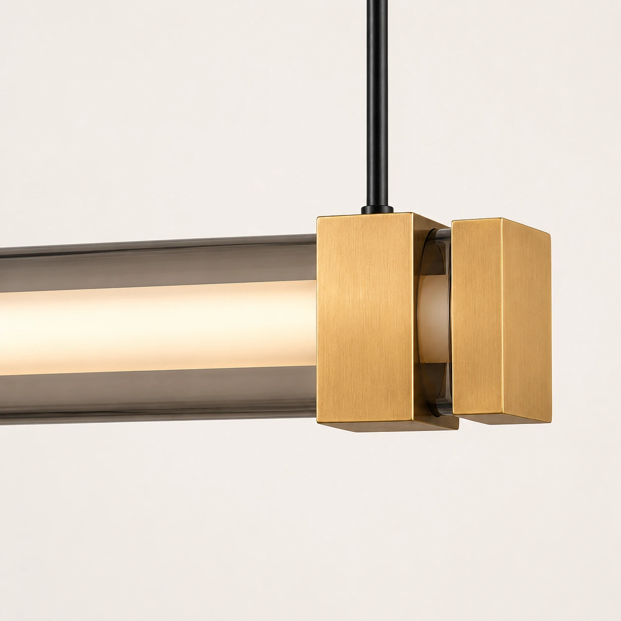 Detail of the OMNI light with smoked glass tube, frosted diffuser and gold fixings