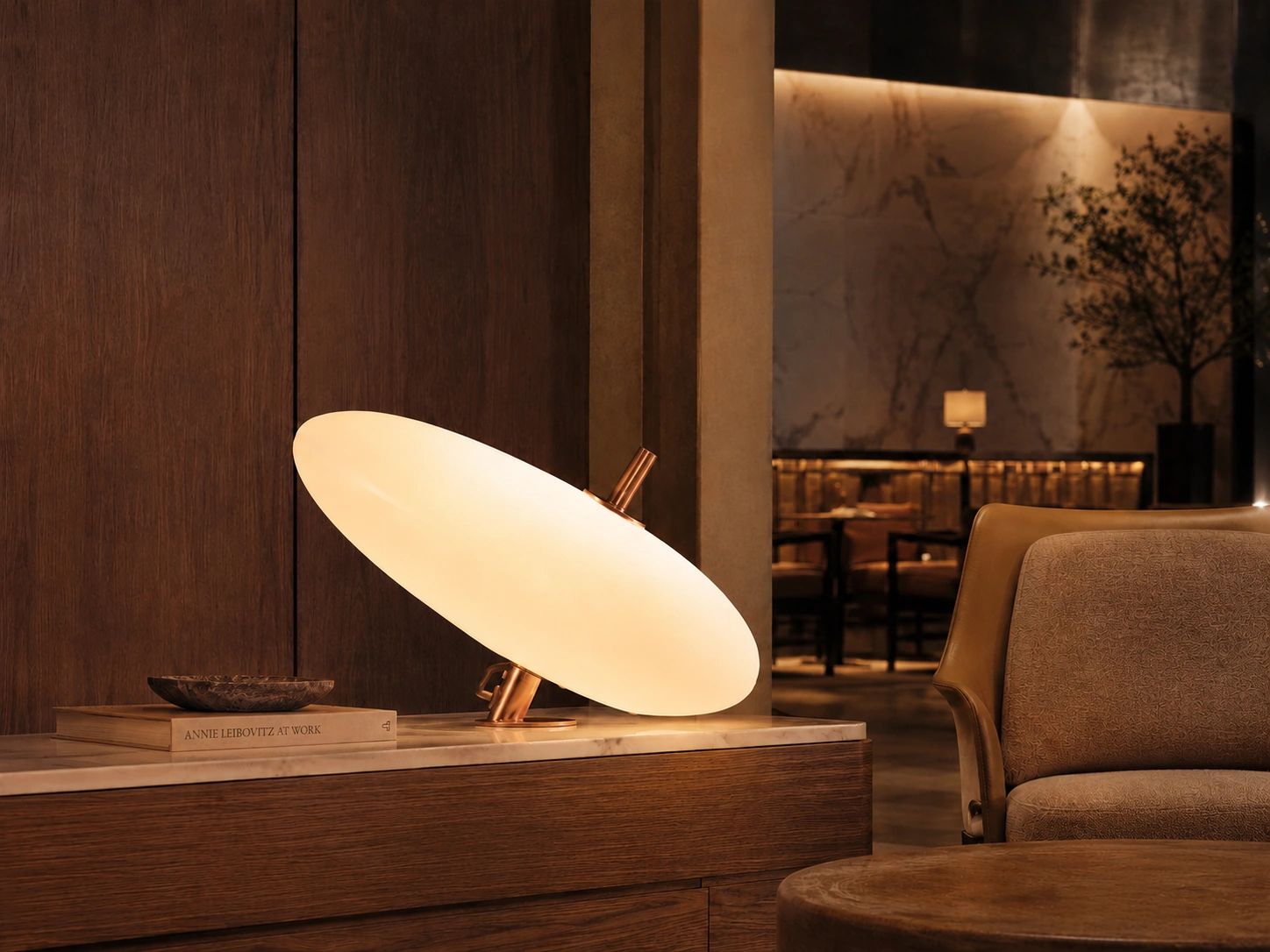GIRO table lamp in a premium hospitality interior with copper finish and oval diffuser